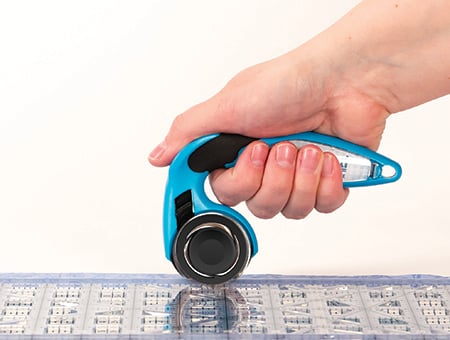 holding rotary cutter with thumb