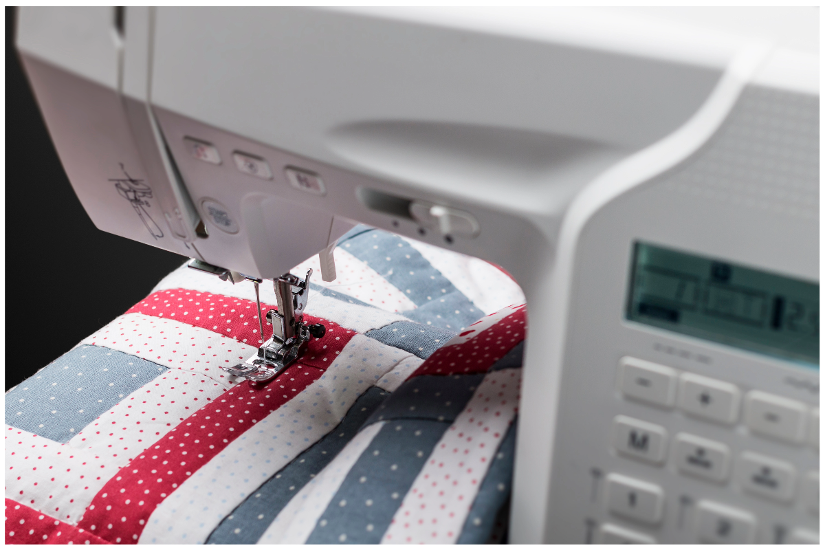 A sewing machine with a red white and blue fabric

Description automatically generated