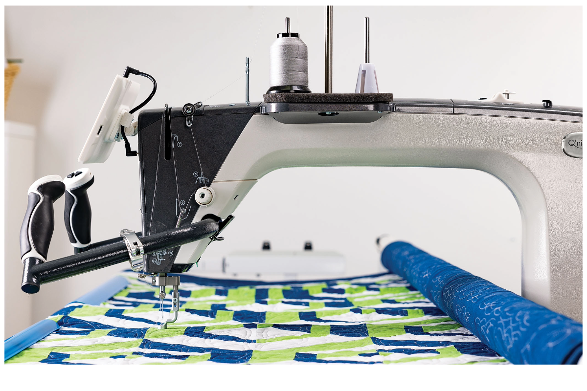 A sewing machine with a roll of fabric

Description automatically generated